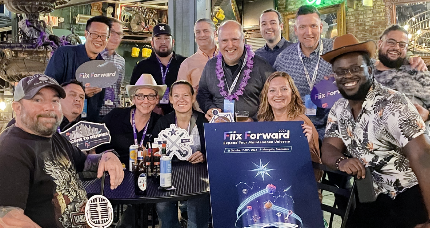 Happy faces holding up the FF24 poster